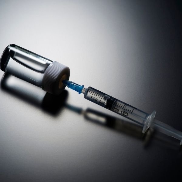 Vaccine being placed into a needle