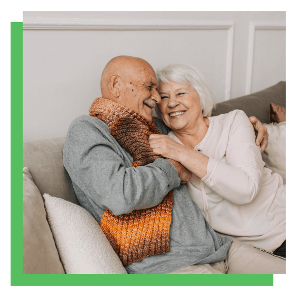 happy senior couple on couch